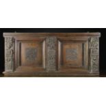A 17th Century Carved Oak Bed-head Section comprising of two recessed panels centred by squares of
