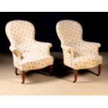 A Pair of Victorian Upholstered Spoon Backed Tub Armchairs on turned walnut legs,