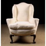 A Queen Anne Style Upholstered Wing Armchair.