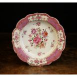 A 18th Century Famille Rose Dish (A/F) decorated with bouquets of flowers in a scrolling trellis