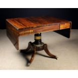A Regency Rosewood Sofa Table with decorative brass inlay.