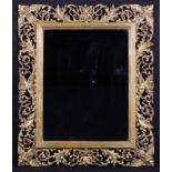 A Rectangular Wall Mirror in an Open Carved Giltwood Frame decorated with undulating scrolls of