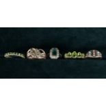 Five Decorative Dress Rings set with Green Stones: One 9 carat gold set with a twist of diamond and