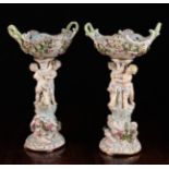 A Pair of Porcelain Figural Comports with Meissen under-glazed blue crossed swords mark (20th