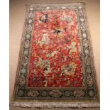 A Fine Persian Carpet woven with huntsmen on horseback,