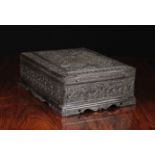 A Finely Carved Indian Ebonised Box decorated with an abundance of flowers and foliage.