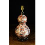 An Early 20th Century Japanese Imari Porcelain Double Gourd Vase, adapted as a table lamp.