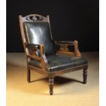 A Late Victorian Armchair with upholstered rectangular back,