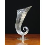 A Venetian Fluted Clear Glass Cornucopia Vase on a round pedestal foot 10½ ins (27 cms) in height.