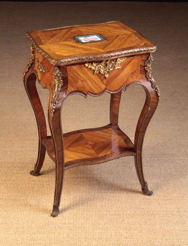 A Small 19th Century Work Table clad in diagonally grained tulip-wood veneers and adorned with gilt