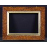 A 19th Century Burr Walnut Picture Frame with a moulded gilt wood liner and two suspension rings to