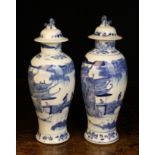 A Similar Pair of Chinese Blue & White Lidded Vases: The baluster bodies rising from a flared foot