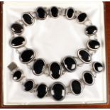 A Silver and Banded Agate Necklace & Bracelet composed of a chain of oval cabochons.