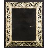 A Rectangular Wall Mirror in an open carved painted wooden frame of undulating foliage;