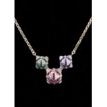 A Chain Necklace set with ruby, emerald and sapphire baguettes surrounded by chip diamonds,