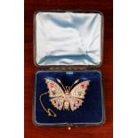 A Delightful Victorian Butterfly Brooch encrusted with paste, green, dark pink and blue stones.