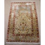 A Fine Quality Persian Silk Rug with an ivory ground mihrab on a pale blue centre panel decorated