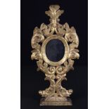 A Small 17th Century Venetian Giltwood Pedestal Mirror.