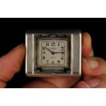 An Art Deco Silver Folding Tavannes Swiss Made Pocket Watch in an oblong machine engraved case with