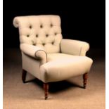 A Comfortable Edwardian Upholstered Armchair with a scroll-topped deep-buttoned back and sprung