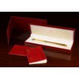 A Cartier Gold Plated Oval Pen fitted in a red and gilt presentation case accompanied by