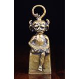 A 19th Century Cast Brass Door Stop by William Tonks & Sons, in the form of a seated goblin,