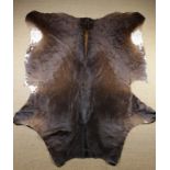 A Cow Hide, 81 ins x 66 ins (206 cm x 168 cms), with retailers label; COW London.