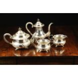 A Chinese Silver Four Part Tea Service, Circa 1880, embossed with intricate floral decoration.