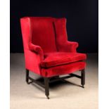 A Georgian Upholstered Mahogany Wing Armchair.