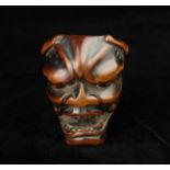An 18th/19th Century Japanese Carved Wooden Netsuke Mask of Hannya, 3 ins x 2¼ ins (7.5 cms x 5.