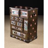 A 19th Century Oriental Lacquered & Porcelain mounted Cabinet fitted with drawers and compartments.