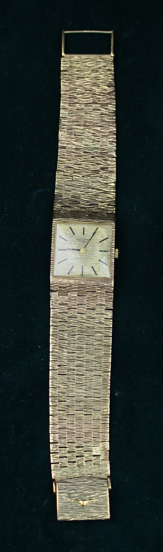 A 9 Carat Gold Longines Wrist Watch on a multi chain link strap.