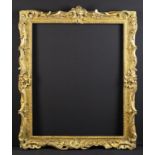 An 18th Century Swept Giltwood Frame carved with Rococo crests and open scrolls of flowers &