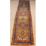 An Antique Caucasian Tribal Runner decorated with repeated motifs in a multi-banded border (A/F)