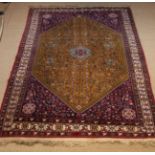 A 20th Century Signed South Persian Abadeh Carpet having a centre medallion on a mustard brown