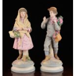 A Pair of Continental Bisque Figures of a Young Man gathering blossom and Woman with basket of