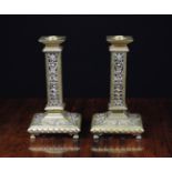 A Pair of Decorative Victorian Brass Candlesticks having hollow square stems with pierced sides