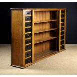 An Late 19th Century Golden Oak Bookcase with adjustable open shelves flanked by banks of nine