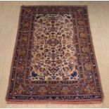 A Persian Rug woven with intricate floral motifs on an ivory ground centre field contained in a
