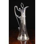 An Art Nouveau Cut Glass Claret Jug with sliver plated mounts, 16½ ins (42 cms) in height.