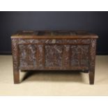 A 17th Century Joined Oak Triple-panelled Coffer. The lid in a channel moulded frame.