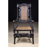 An Ebonized Charles II Carved & Caned Armchair with decorative pierced framework incorporating