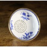 A Pretty 18th Century Limoges Enamel Tea-strainer hand painted in blue with sprigs of flowers.