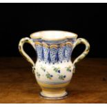 A Late 18th/Early 19th Century French Faience Vase with lobed rim and twin handles,