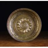 A 15th Century Nuremberg Alms Bowl with a wrythen rosette centred by a emblem roundel of St John