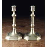 A Pair of 18th Century Brass Candlesticks with knopped octagonal stems and square canted bases,