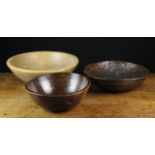 Three Treen Bowls: A 19th century sycamore dairy bowl (cracked) 18 in (46 cms) in diameter,