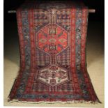 An Antique Caucasian Wool Runner woven in red, mid blue,