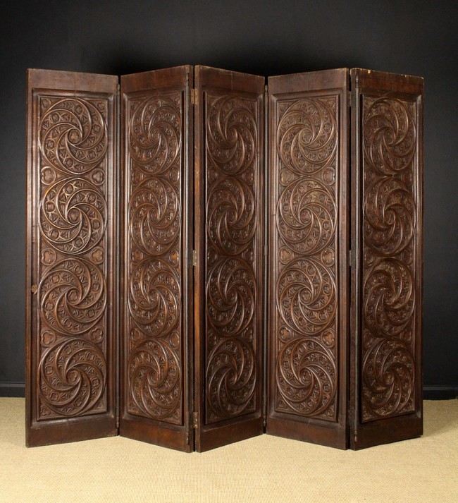 A Large Oak Five Fold Screen carved with Gothic style tracery.