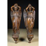 A Pair of Large 18th Century Wall Mounted Figural Supports carved in the form of winged angels